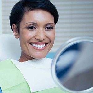 Woman looking in to the mirror and smiling