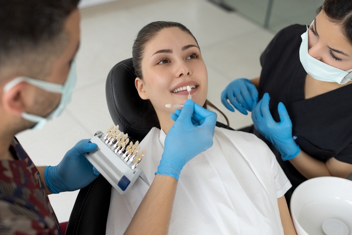 A smiling person showing even white teeth after getting dental veneers in Highland, IN.