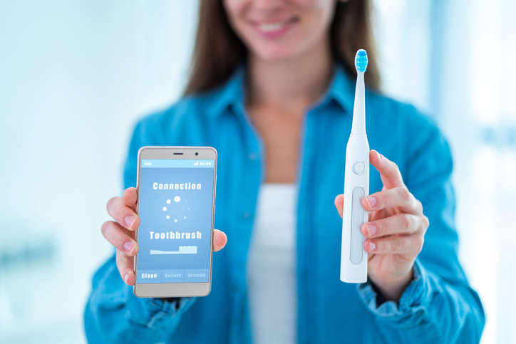 Wireless connection ultrasonic electric toothbrush with smart phone app. Modern home technology concept, smart toothbrush